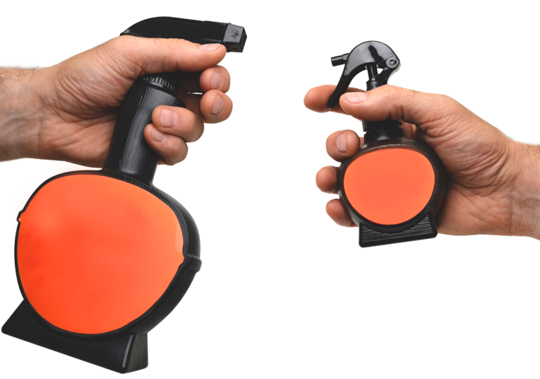 Hands holding a large and a small plastic trigger spray bottle in black and red