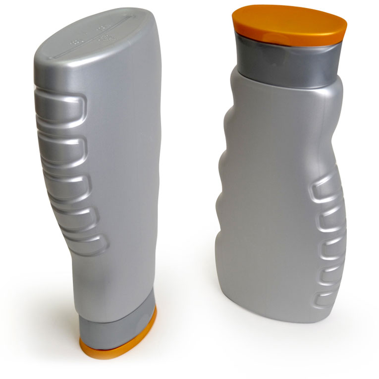 Two grey showergel bottles with orange caps, one standing upside down